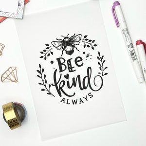 May include: Black and white printable art print with a bee and floral design. The text reads "Bee Kind Always".