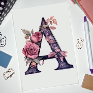 May include: A watercolor illustration of the letter A decorated with pink roses and purple leaves. The letter is outlined in black and has a dark purple background.