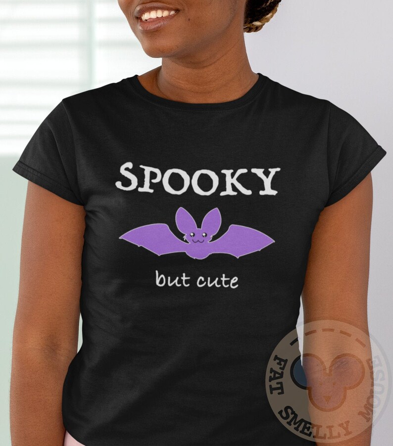 May include: Black t-shirt with a purple bat graphic and the text "Spooky but cute".