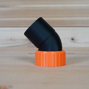 May include: A black plastic 90-degree elbow pipe fitting with an orange threaded connector.