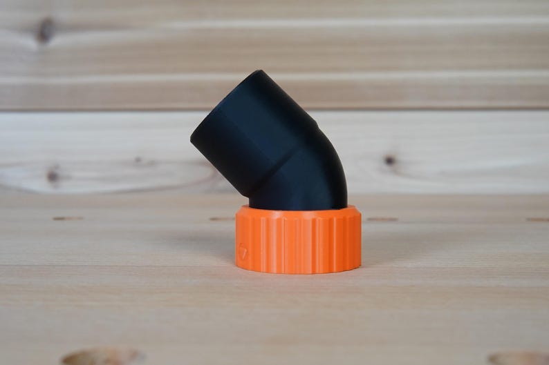 May include: A black plastic 90-degree elbow pipe fitting with an orange threaded connector.