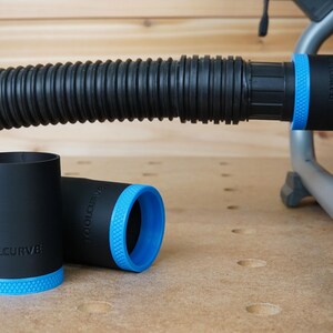 May include: Three black and blue dust collection adapters with the text "TOOLCURVE" printed on them. The adapters are designed to connect to a vacuum hose.