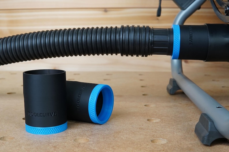 May include: Three black and blue dust collection adapters with the text "TOOLCURVE" printed on them. The adapters are designed to connect to a vacuum hose.