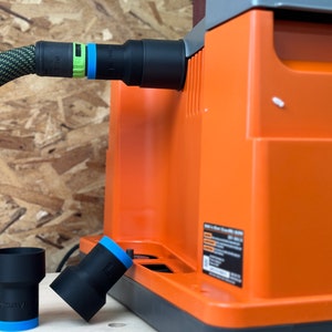 May include: A black and orange dust collector with a black hose and a green and blue connector. Two black dust collection adapters with blue trim are on a wooden surface.