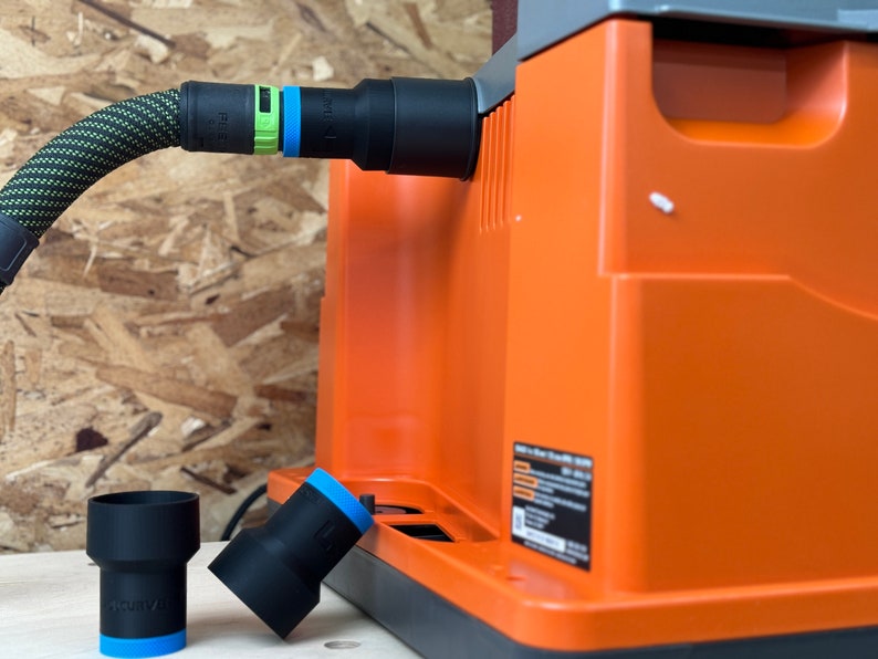 May include: A black and orange dust collector with a black hose and a green and blue connector. Two black dust collection adapters with blue trim are on a wooden surface.