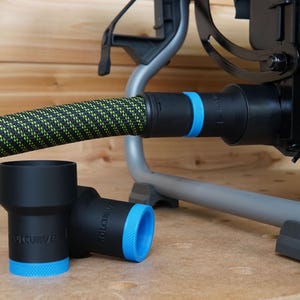 May include: Two black and blue dust collection adapters with the word "TOLCURVE" printed on them. The adapters are connected to a black and green hose.