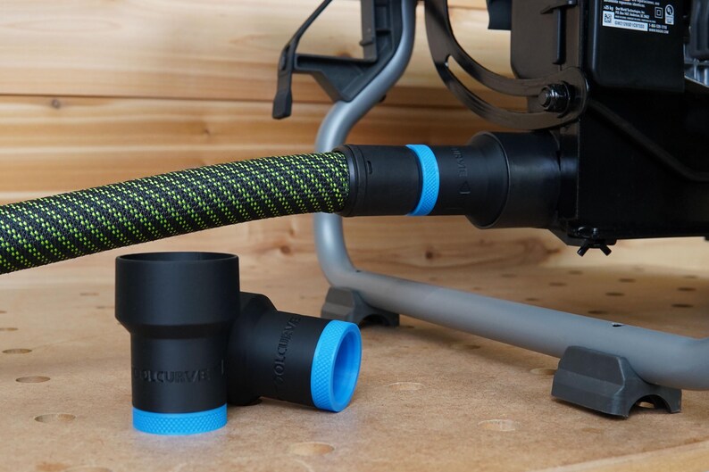 May include: Two black and blue dust collection adapters with the word "TOLCURVE" printed on them. The adapters are connected to a black and green hose.