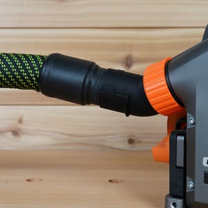 May include: A black and orange power tool with a green and black hose attached. The tool has a label that says "BRUSHLESS".