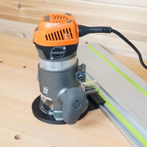 May include: An orange and gray power router with a black power cord and a silver guide rail. The router has a clear plastic guard and a black base. The guide rail has a green stripe.