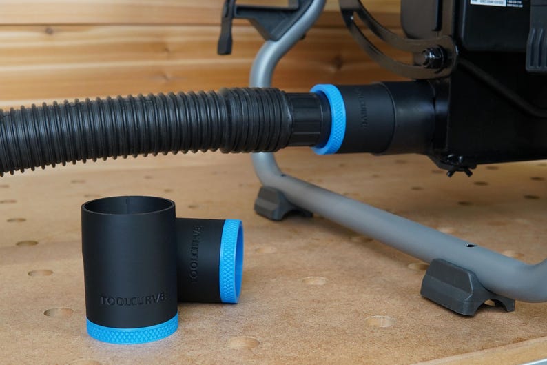 May include: Two black dust collection adapters with blue accents and the text "TOOLCURVE" printed on them. The adapters are designed to fit a dust collection hose.