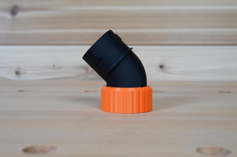 May include: Black plastic 90-degree elbow pipe fitting with an orange threaded connector.