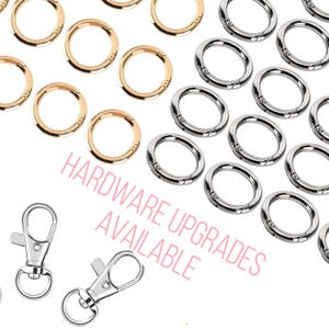 May include: A close-up of two silver swivel clasps and a variety of gold and silver jump rings. The text "HARDWARE UPGRADES AVAILABLE" is written in pink below the rings.