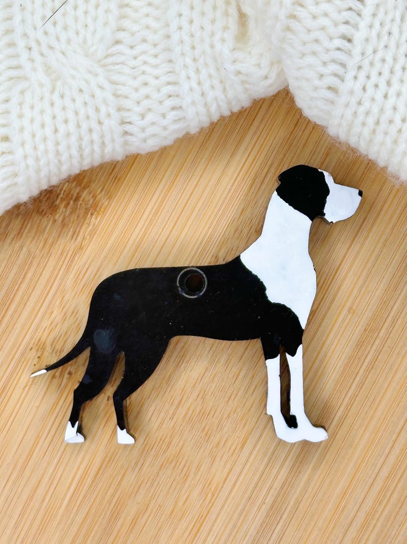 May include: Black and white wooden cutout of a Great Dane dog. The cutout has a hole in the top for hanging.