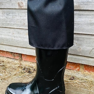 May include: Black rubber rain boots with a black fabric gaiter that has an elastic top.