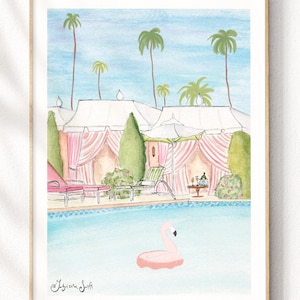 May include: Watercolor print of a resort scene with a pool and a pink flamingo float. The artwork features cabanas with pink curtains, palm trees, and a light blue sky. The print is framed in a light wood frame.