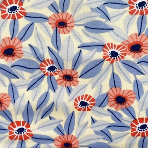 May include: A white fabric with a repeating pattern of blue leaves and pink and orange flowers. The flowers have a dark blue centre.