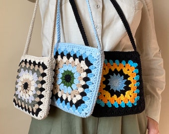 May include: Three crocheted bags with different colored patterns. The bags are all square and have a single strap. The patterns are a light green, blue, and orange.