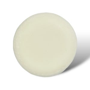 May include: A round, white, solid bar of soap.