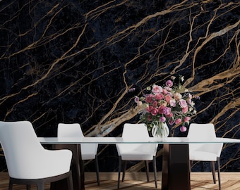 May include: A dining room table with four white chairs and a glass top. The table is set with a vase of pink flowers. The wall behind the table is covered in a black and gold marble wallpaper.