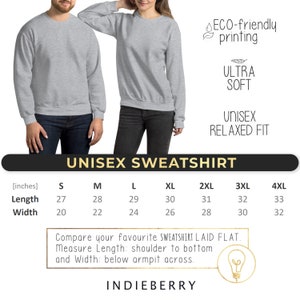 May include: Two people wearing light gray unisex sweatshirts. The image includes text that reads "UNISEX SWEATSHIRT", "ULTRA SOFT", and "UNISEX RELAXED FIT". Size chart shows length and width measurements in inches for sizes S to 4XL. The brand name "INDIEBERRY" is also visible.