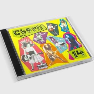 May include: A CD case featuring the album "Charli" by XCX. The cover is bright yellow with various images of the artist and the text "Charli" in a green, stylized font. The case has a black spine and a parental advisory warning.