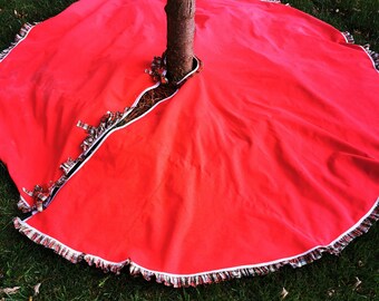 Upcycled Christmas Tree Skirt 77” diameter, edged with plaid ruffle and closes with bowed tartan pins