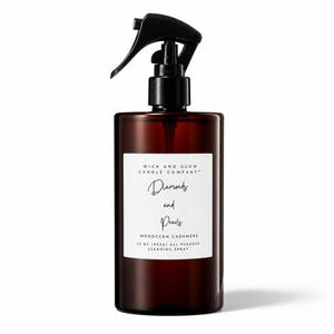 May include: A dark amber plastic spray bottle with a black trigger nozzle. The white label reads: WICK AND GLOW CANDLE COMPANY, Diamonds and Pearls, MOROCCAN CASHMERE, 16 OZ (453G) ALL PURPOSE CLEANING SPRAY. The bottle has a cylindrical shape.