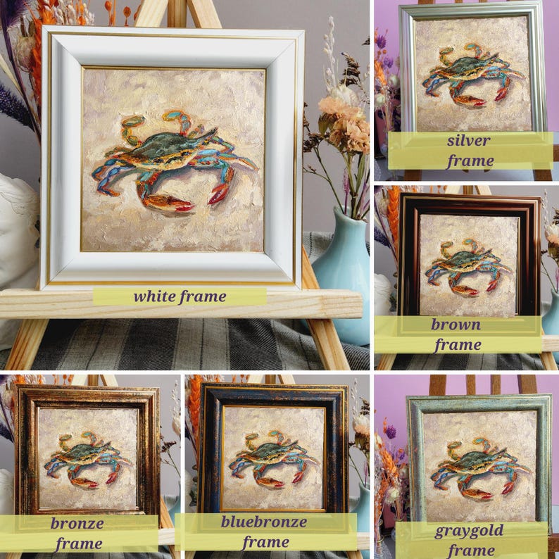 May include: A square painting of a crab in shades of blue, green, and red, set in a white frame with a gold inner edge. The image is displayed on a wooden easel, showcasing the artwork's details and colors.