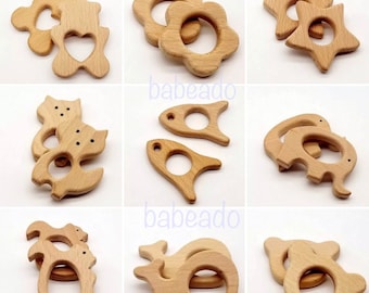 May include: Set of 10 wooden teethers in various shapes, including a star, flower, rocket, whale, elephant, cat, and bear. The teethers are made of natural wood and are safe for babies to chew on.