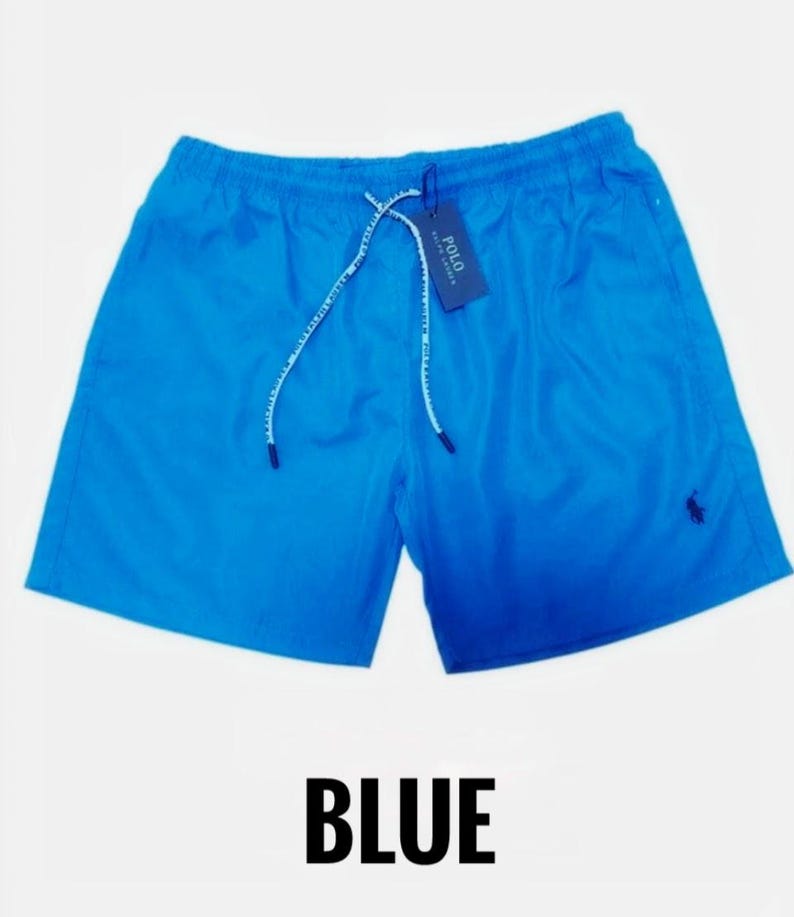 May include: Bright blue swim shorts with a drawstring waist and a small logo on the leg. The shorts have a tag attached. The word "BLUE" is printed in large, bold letters at the bottom of the image.