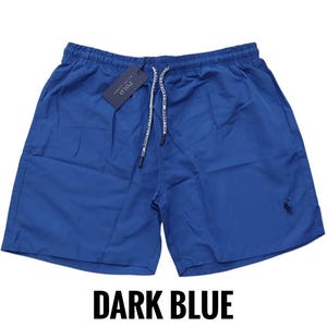 May include: Dark blue shorts with a drawstring waist and a small logo on the lower right leg. The shorts have a tag attached with the brand name. The text "DARK BLUE" is at the bottom of the image.