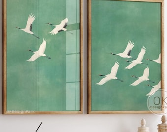 May include: Two framed art prints featuring white cranes in flight against a teal green background. The prints are displayed above a wooden cabinet. The art prints are a digital download from OKDesignPark.etsy.com.