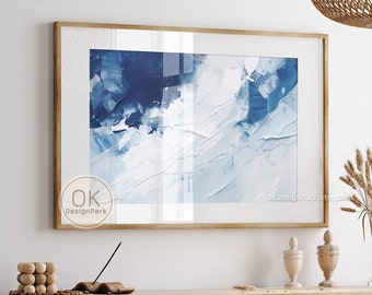 May include: A framed abstract art print with shades of blue and white. The artwork is displayed above a wooden cabinet with woven cane doors. The image also shows a dining table and chairs, and decorative items, creating a modern, minimalist aesthetic. The text "DIGITAL DOWNLOAD OKDesignPark.etsy.com" is visible.