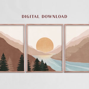 K&ouml;nnte beinhalten: Ein Set aus drei digitalen Drucken, die eine minimalistische Landschaft mit Bergen, einem See und einer gro&szlig;en Sonne zeigen. Die Drucke haben ein Verh&auml;ltnis von 3:4 und eine ged&auml;mpfte Farbpalette in Braun-, Rosa- und Blaut&ouml;nen.