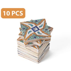 May include: A stack of 10 colorful ceramic tiles with a geometric pattern in shades of blue, green, orange, and white. The tiles are arranged in a staggered pattern, with the top tile showing the full design.  10 PCS