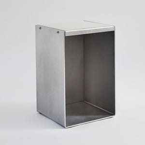 May include: A silver metal storage box with a square shape and open top. The box is made of metal and has a brushed finish.