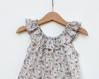 White ruffled dress and paisley patterns