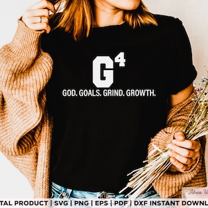 May include: A black t-shirt with a white graphic design that says "G^4 GOD. GOALS. GRIND. GROWTH."