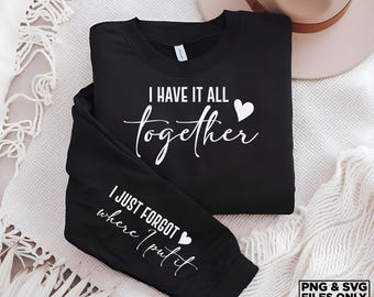 May include: Black sweatshirt with white text that reads "I have it all together" and a small heart. The sleeve has white text that reads "I just forgot where I put it" and a small heart.