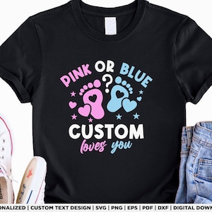 May include: Black t-shirt with the text "PINK OR BLUE? CUSTOM loves you" in pink, blue, and white. The design includes footprints, hearts, and stars, suggesting a gender reveal theme. A pair of white Converse sneakers and denim jeans are visible.