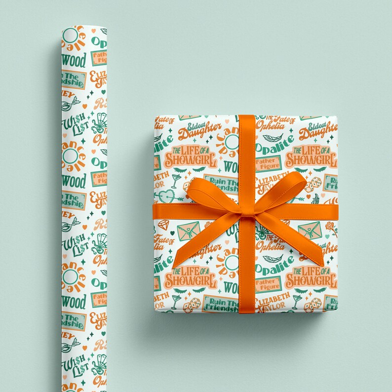 May include: Gift wrapping paper and a wrapped gift with an orange bow. The paper has a white background with a repeating pattern of text, suns, and other graphics in orange and teal. The wrapped gift has the same pattern.