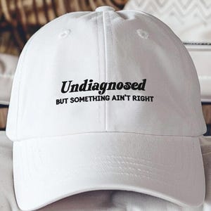 Undiagnosed But Something Ain’t Right Hat, Embroidered Mental Health Humor Cap, Funny Sarcastic Quote Dad Hat, Snarky Statement Hat