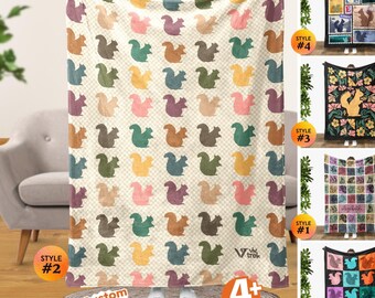 May include: A cream white throw blanket featuring a repeating pattern of squirrels in various colors including pink, blue, green, and brown. The blanket has a subtle checkered background and the Vtrek logo in the bottom corner. Four additional styles are shown.