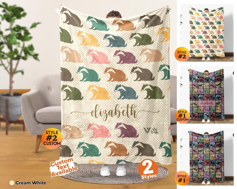 May include: A cream white throw blanket featuring a repeating pattern of illustrated badgers in various colors including brown, green, yellow, pink, and purple. The center displays the name elizabeth in cursive script and the logo viv trek.
