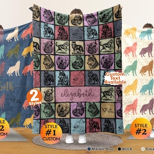 May include: Three blankets featuring wolf illustrations. The left blanket is blue with multicolored wolf silhouettes and the name elizabeth. The center blanket has a grid of wolf portraits and the name elizabeth. The right blanket is cream with wolf silhouettes.