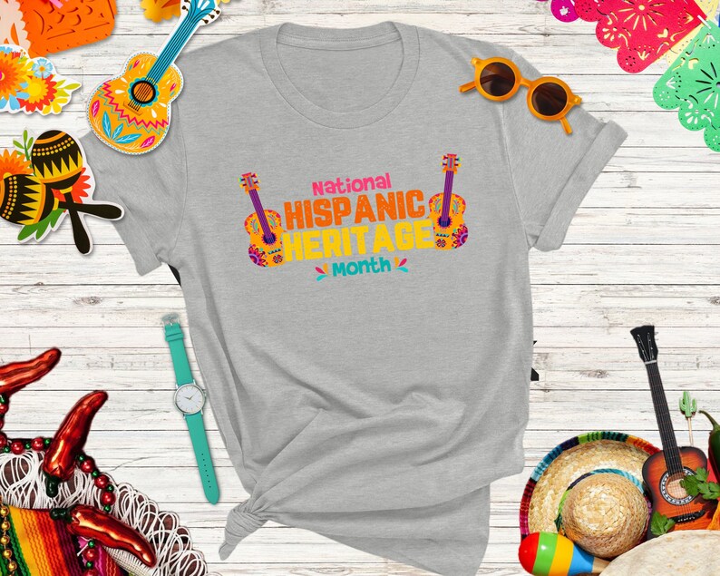 May include: A gray t-shirt with the text "National Hispanic Heritage Month" and a colorful guitar graphic.