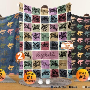 May include: Three rectangular blankets featuring shark illustrations. The center blanket has a grid pattern with various shark poses and the name elizabeth in a central box. The left and right blankets feature repeating shark patterns with custom text.