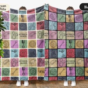 May include: A cream white and black blanket featuring a patchwork design with mechanical engineering tools and the text "MECHANICAL ENGINEER" in a grid pattern. The blanket displays wrenches, gears, and pistons in various colors.