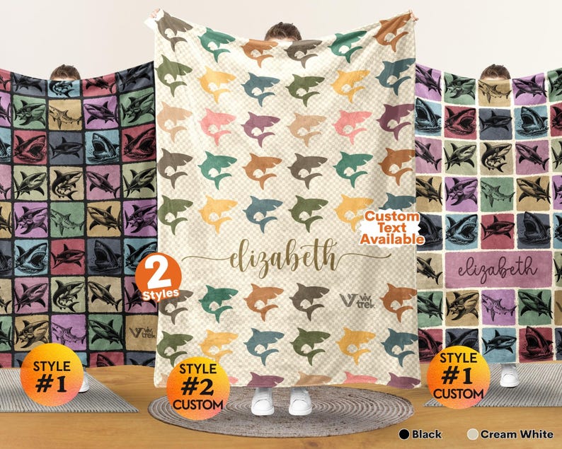 May include: Three soft blankets featuring shark patterns. The left blanket has a grid of sharks on dark backgrounds. The center blanket is cream white with colorful sharks and the name elizabeth. The right blanket has a grid with the name elizabeth.