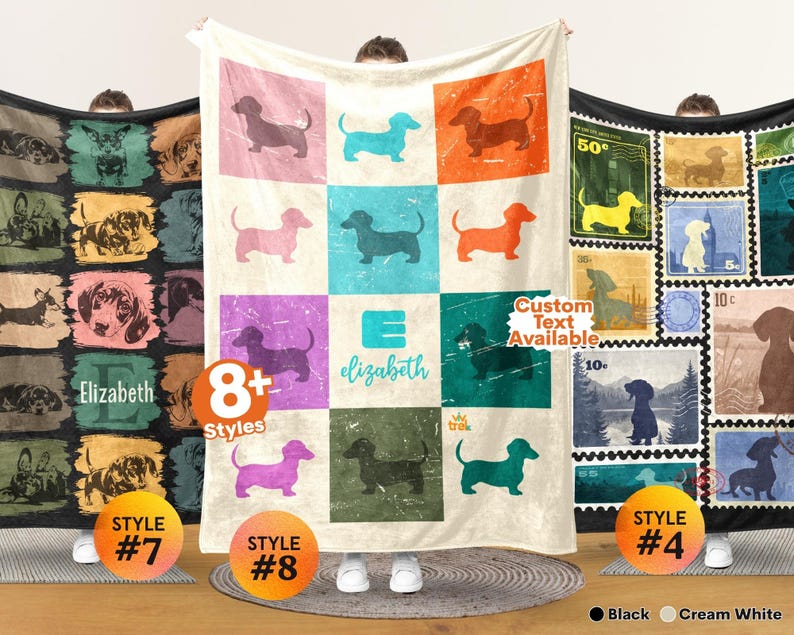 May include: A cream-colored throw blanket featuring a grid of twelve squares, each displaying a silhouette of a dachshund in various colors. The center square includes the letter E and the name elizabeth in teal script text.